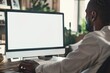© Periksa - Mature Black Guy Typing on Computer Keyboard with Blank Screen, Recommends Website in Living Room