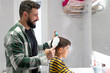 © Antonio Recena - 40 years old Father combing his son's hair in the bathroom of their home