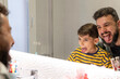 © Antonio Recena - Father and son showing tongue on bathroom mirror