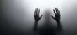 © Studio Nova - The haunting silhouette of hands pressed against a foggy surface.