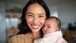 © iuricazac - Smiling woman holding baby in indoor setting