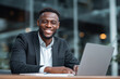© mattegg - Smiling businessman at desk with laptop