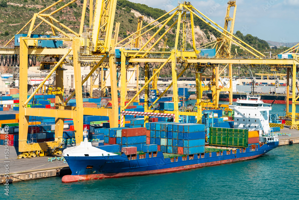 Cargo ship docked at container terminal with yellow cranes Stock Photo ...