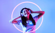 © Prostock-studio - Favorite music concept. Asian woman in headphones with neon circle