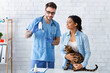 © Prostock-studio - Owner of cute tabby cat and veterinary doctor with meds in animal hospital