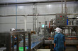 © FotoArtist - Workers operate machinery in a food processing factory during daytime hours