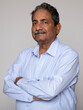 © Pix4Ads - Portrait of an indian happy senior elderly man face with arm crossed isolated on grey background. Old age man healthcare lifestyle, after retirement concept