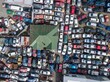© Zenstratus - Aerial view of a car junkyard in Waipawa, Hawke's Bay, New Zealand, where damaged vehicles are stored for parts and recycling, contributing to sustainable waste management.