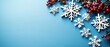 © moerba - Festive winter scene with white snowflakes and red berries arranged on a light blue background, leaving ample copy space