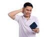 © Sewupari Studio - Sad young Asian man in white polo shirt holding empty wallet and touching neck with regretful expression isolated on transparent background