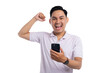© Sewupari Studio - Happy Asian man celebrating success while looking at smartphone with raised fist isolated isolated on transparent background
