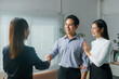 © Crystal - Young couple shaking hands with real estate agent after finalizing their contract, celebrating the exciting purchase of their new home