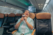 © Me studio - Passenger Asian Mature Woman show passport Smiling On Plane