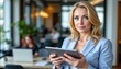 © K silver - Business professional using tablet to enhance productivity modern office space digital communication contemporary environment focused viewpoint