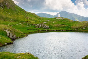 Wall Mural - alpine lake in fagaras mountains. fantastic adventures in romania. rippled water surface