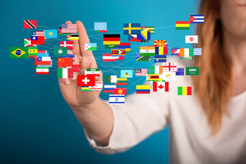 Poster - Image of a woman's hand interacting with a network of interconnected world flags, representing global communication and connection.