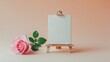 © AkuAku - Bright rose flower beside blank painting canvas on peach background with ample copy space. Minimal art featuring blossom rose layout. Creative aesthetic vibe for developing new ideas.
