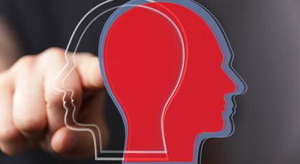 Aufkleber - Stock photo of a hand pointing at overlapping head silhouettes, symbolizing understanding different viewpoints.