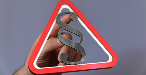 Aufkleber - Image of a hand holding a paragraph symbol inside a red warning triangle.  Perfect for legal, law, and regulation concepts.