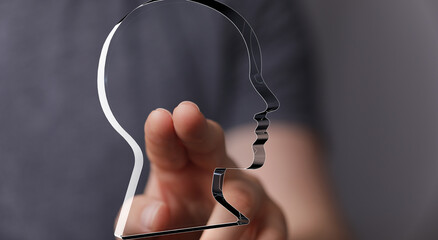 Aufkleber - Abstract image of a hand interacting with a head shape, symbolizing ideas, thoughts, or mental health.