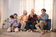 © Hip.hub - Joyful family gathering in a cozy living room sharing laughter and affection during a joyful moment together