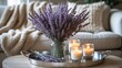 © VirtualVista - Coffee table design idea featuring aroma candles and a dried lavender bouquet on a metal tray, with a sofa draped in a blanket in the background. Simple home decor concept.