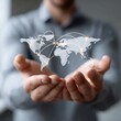 © pixraw - Global Network Connectivity:  A Businessman's Hands Cradle a World Map Illustrating Interconnectedness and International Business Opportunities.
