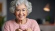 © venusvi - Cheerful elderly woman knitting at home, enjoying her hobby while embracing creativity and relaxation.