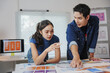 © Crystal - Software developers collaborating on mobile application design during a meeting in a modern office environment, surrounded by technology and creativity