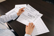 © brizmaker - Reviewing utility statement and related documents at a home office desk