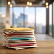 © Abuustman - Stack of documents on a desk, blurred office background
