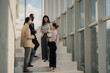 © Zamrznuti tonovi - Business people talking on stairs in modern office building