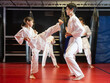 © JackF - Child boy and girl partners during martial arts karate class train to perform basic blows to opponent with hands and feet, working in pairs, striking opponent. Preparation of athletes for competitions