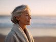 © SolaruS - Serene mature woman at sunset on the beach. Profile view evokes peace, wisdom, reflection. Ideal for health, wellness, lifestyle, and travel concepts.