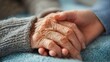 © Justlight - Closeup of a Christian volunteer holding the hand of an elderly person, providing them with companionship and support in a nursing home.