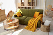 © Pixel-Shot - Interior of living room with green sofa and pumpkins