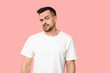 © Pixel-Shot - Handsome worried young man on pink background