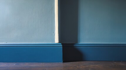 Aufkleber - Teal and light blue painted walls with dark wood baseboards and floor.