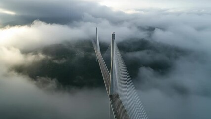 Wall Mural - a very long and high bridge emerging through thick morning fog, blending iconic architecture with dr