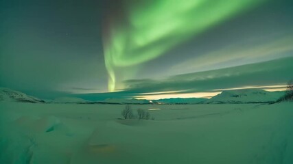 Wall Mural - vibrant green aurora borealis illuminating pristine snow covered valley during twilight, casting mes