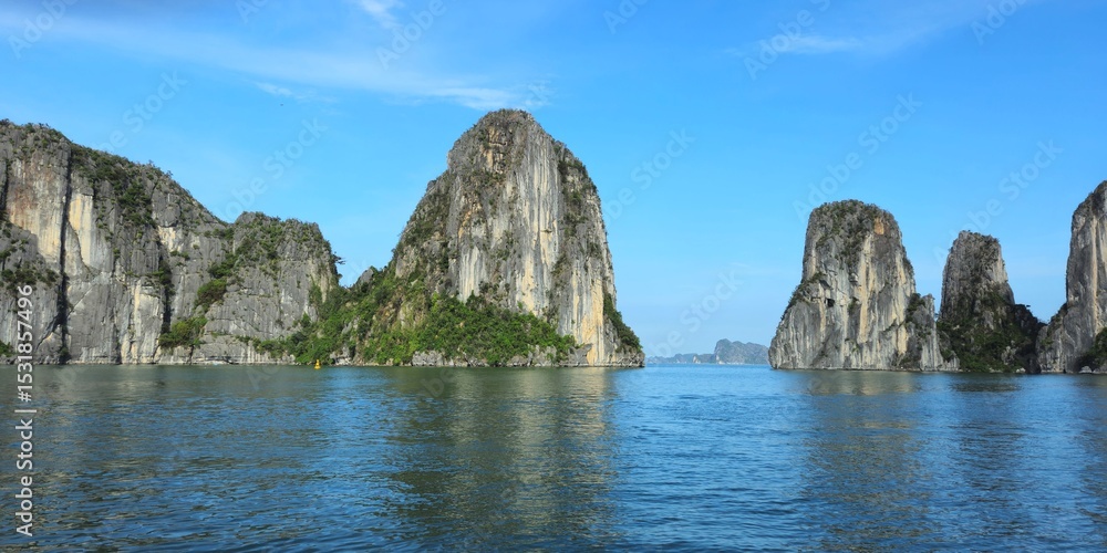 towering-limestone-karsts-rise-from-the-calm-emerald-waters-of-ha-long
