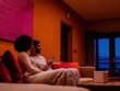 © Irfan - Couple relaxing indoors at night