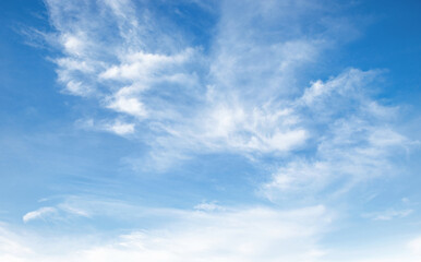 Wall Mural - sky is blue and clear with clouds. The sun is shining brightly, making the sky look even brighter. Scene is peaceful and serene