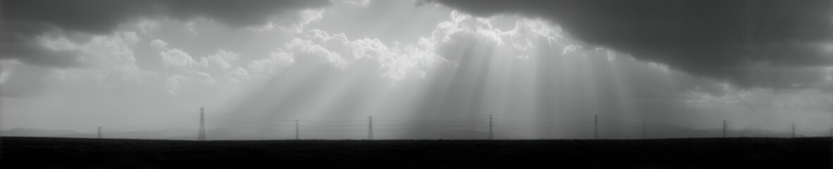 Leinwandbilder - Dramatic Silhouette of Electrical Transmission Towers with Power Lines and Sunbeams for Energy Sector Marketing and Modern Grid Infrastructure