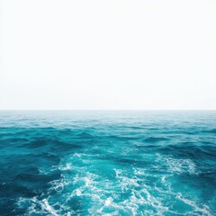 calm ocean waves meet a bright white sky