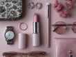 © sirisakboakaew - Pink Beauty Essentials Flatlay: A stylish flatlay showcasing pale pink lipstick, elegant jewelry, a wristwatch, sunglasses, and makeup brush, arranged on a soft pink background.