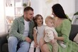 © New Africa - Happy parents and their kids together on sofa at home