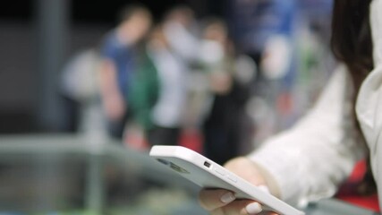 Woman is holding a cell phone and texting. Concept of modern technology and communication