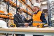 © Koldo_Studio - Manager and worker shaking hands in warehouse, logistics, delivery, distribution, supply chain, teamwork, partnership, success
