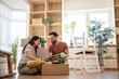 © Migma_Agency - Happy couple unpacking cardboard boxes and furnishing new home